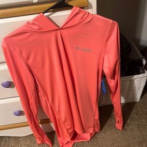 The brand is Columbia, it’s neon pink with white lettering